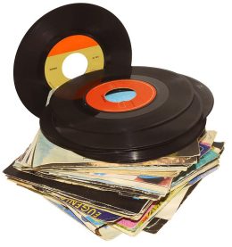 A pile of 45 RPM vinyl records used and dirty even if in good condition